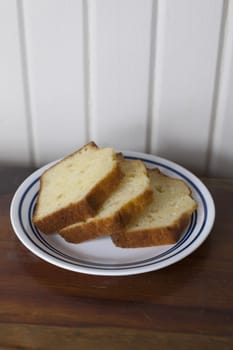 Three slices of pound cake on a small plate