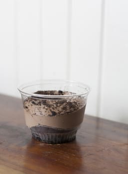 Single portion of cholocate pudding in a clear container