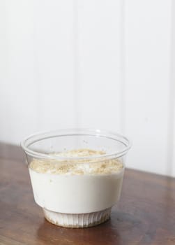 Single serving of vanilla pudding in a small, clear container