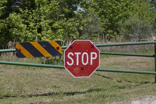 Stop sign on a gate indicating a blocked road