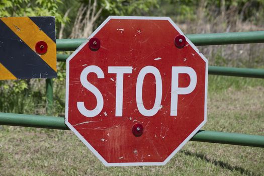 Stop sign on a gate indicating a blocked road