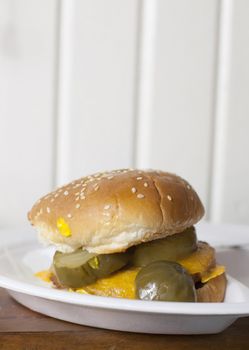 A single veggie burger with cheese and pickles