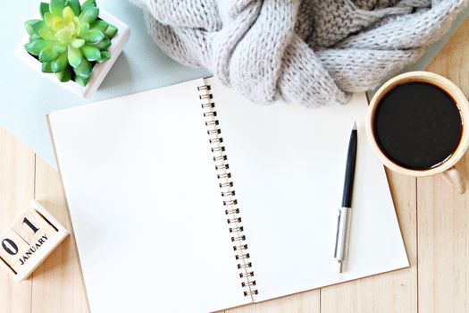 Business, holiday or new year planning concept : Desk table with scarf, notebook paper, cube calendar and coffee cup, Top view or flat lay with copy space ready for adding or mock up