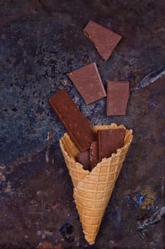 Chocolate in waffle cone chocolate concept on a grunge background