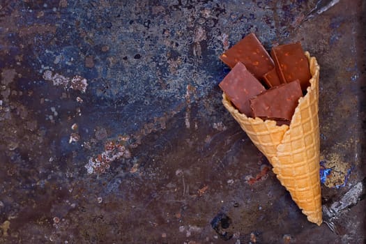 Chocolate in waffle cone chocolate concept on a grunge background