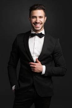 Portrait of a handsome young man wearing a tuxedo