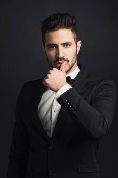 Portrait of a handsome young man wearing a tuxedo