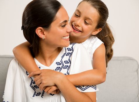 Beautiful Mom and Daughter having fun at home