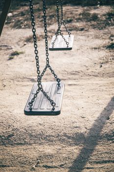 two black seats in the park