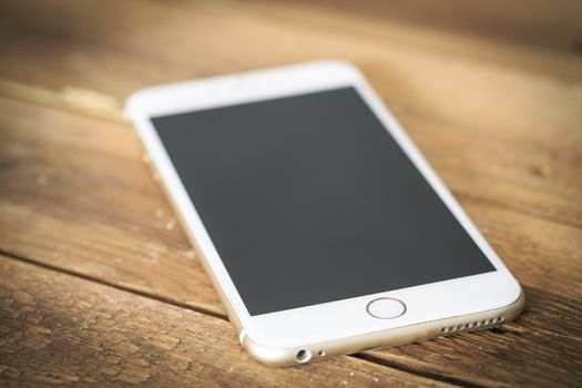 Smart phone on the wooden table