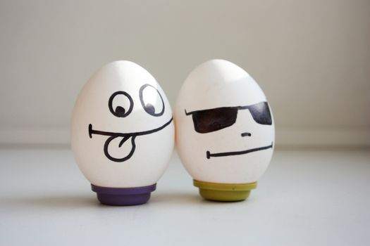 funny and funny eggs. two eggs for Halloween. smiling. masquerade in glasses. photo for your desig