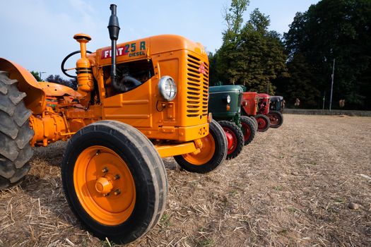 Five old tractors in perspective, agricultural vehicle, rural life