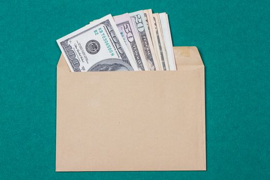 cash in an envelope on a green background