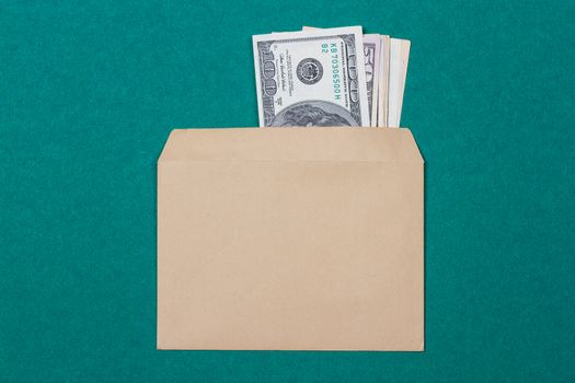 cash in an envelope on a green background