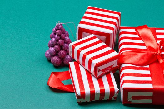 Christmas gift boxes on green background. Top view with copy space