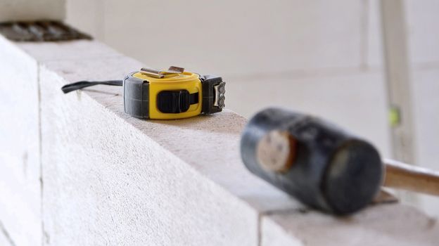 Work tools put on a autoclaved aerated concrete blocks wall.