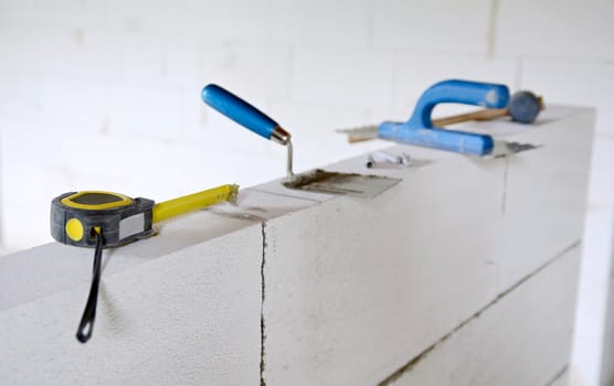 Work tools put on a autoclaved aerated concrete blocks wall.