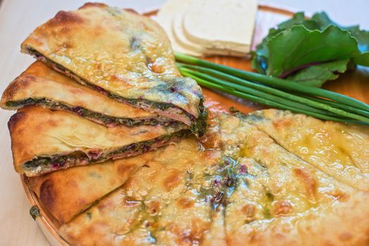 ossetian pie with beetroot onion and cheese on a white background