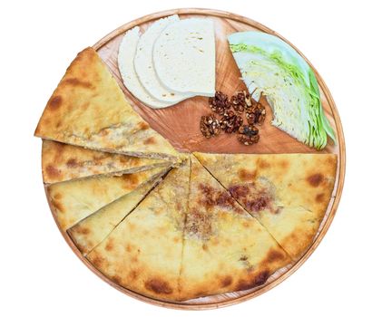 ossetian pie with cabbage and nuts on a white background