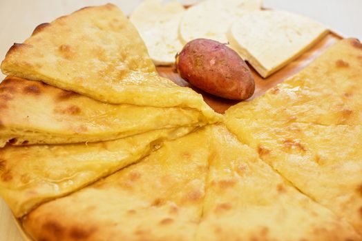 ossetian pie with potato and cheese on a white background