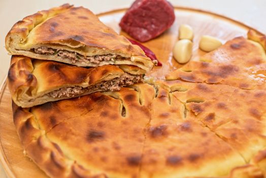 Meat ossetian pie on a white background