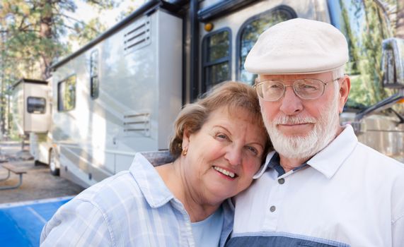 Senior Couple In Front of Their Beautiful RV At The Campground.