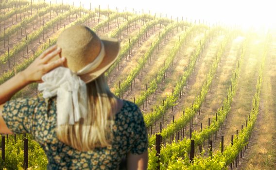 Beautiful Woman Strolling at a Winery on a Spring day.