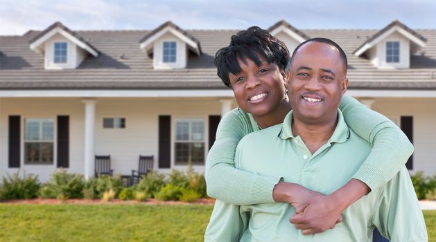 Happy African American Couple In Front of Beautiful House.