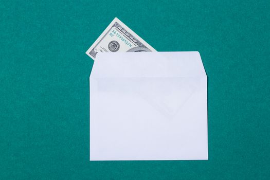 cash in an envelope on a green background