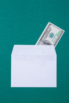 cash in an envelope on a green background