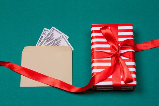 Concept: a gift or money. american money with gift box on a green background