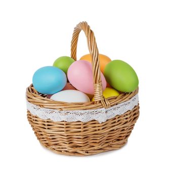 Wicker basket with multicolored Easter eggs isolated on white background