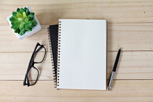 Business, education, still life, working or planning concept : Office desk table with open notebook paper, pen and eyeglasses, Flat lay or top view with copy space, ready for adding or mock up