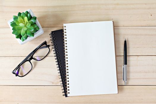 Business, education, still life, working or planning concept : Office desk table with open notebook paper, pen and eyeglasses, Flat lay or top view with copy space, ready for adding or mock up