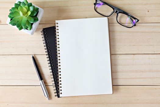 Business, education, still life, working or planning concept : Office desk table with open notebook paper, pen and eyeglasses, Flat lay or top view with copy space, ready for adding or mock up