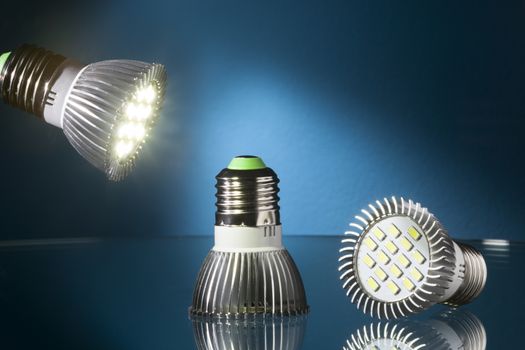 Energy saving  led lights on a glass table and blue background