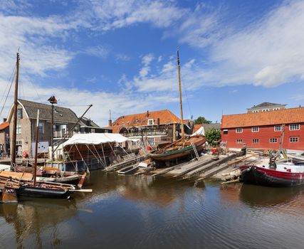 Historic shipyard with wooden fishing boats in the harbor of the village Spakenburg in the Netherlands. 