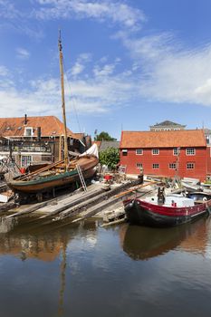 Historic shipyard with wooden fishing boats in the harbor of the village Spakenburg in the Netherlands. 