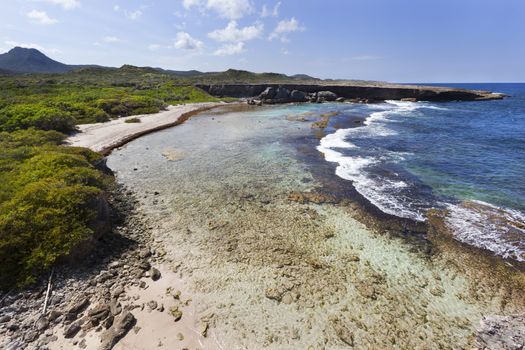 Coastline of  Boka Grandi in Christoffel National Park on Curacao with Mount Christoffel on the left side in the distance 