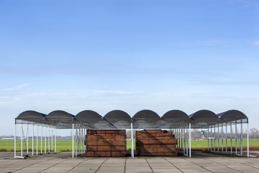 Outdoors industrial storage of piles hardwood under a roof