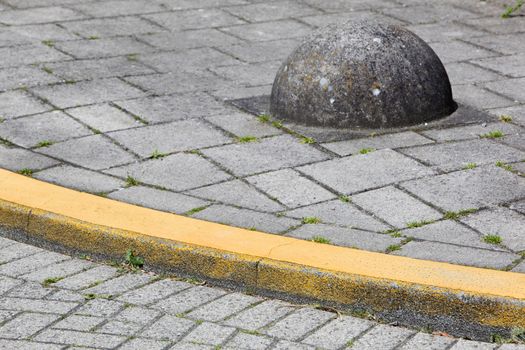 Yellow curb and obstacle on a street corner in the Netherlands