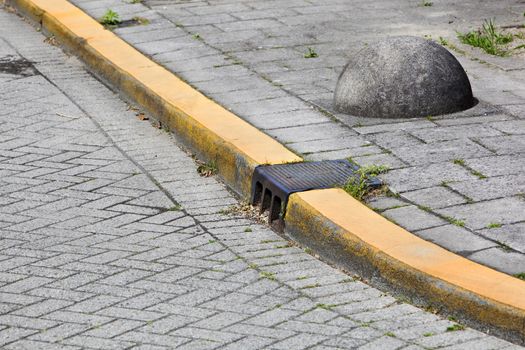 Yellow curb and obstacle on a street corner in the Netherlands