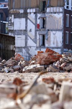 Demolition of residential district Crooswijk in Rotterdam, the Netherlands. There’s some of rubble around a builders skip. It looks a bit like a warzone.