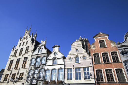 Facade of 18th century buildings at the Grote Markt (Large market square) in Mechelen, Belgium.  A blue sky makes the buildings even more attractive.  