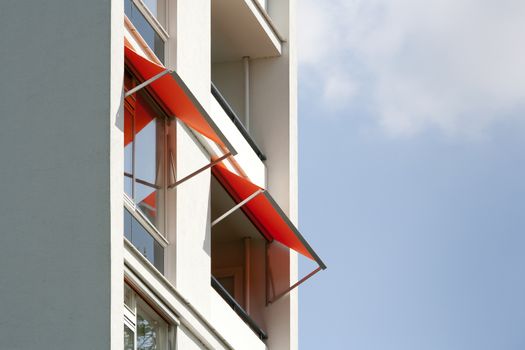 Orange awnings on a white apartment block