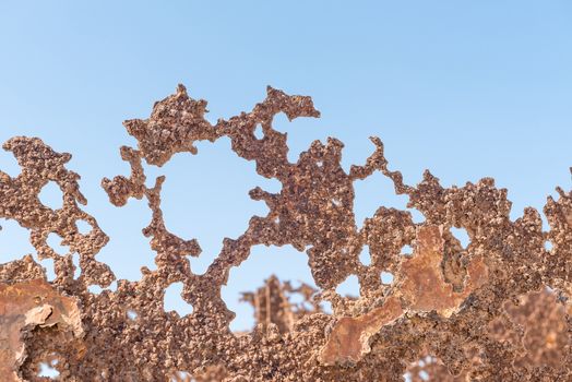 Rusted metal remains of an abandoned oil drilling rig between Henties Bay and Torra Bay in the Skeleton Coast area of Namibia