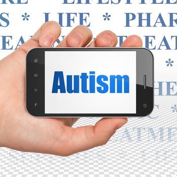 Medicine concept: Hand Holding Smartphone with  blue text Autism on display,  Tag Cloud background, 3D rendering