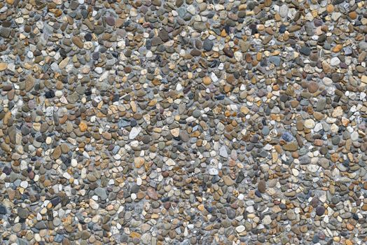 Background photo of colored gravel in a concrete precast slab that serves as wall covering
