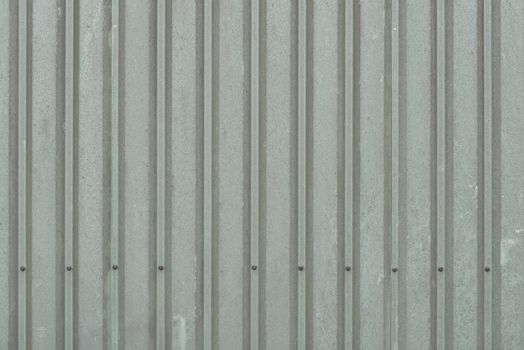 Background of weathered dark green metal wall panels on a barn
