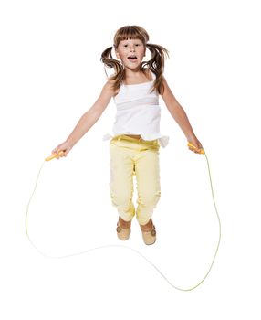 Seven years Girl jumping with skipping rope isolated on white